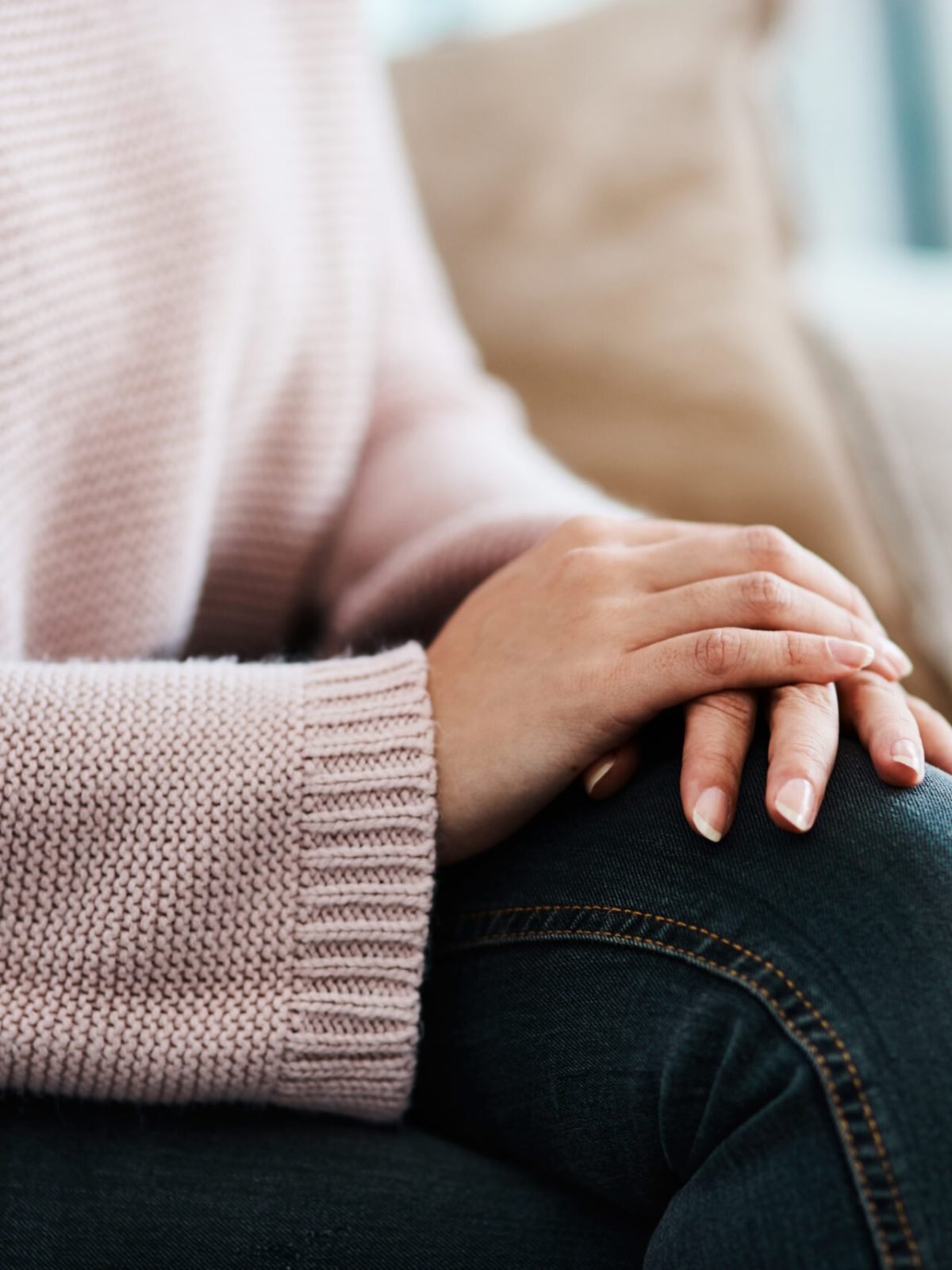 Patience is the path to peace. Cropped shot of a woman sitting on a sofa at home